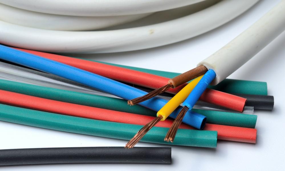A bundle of heat shrink tubing in multiple colors, including red, green, blue, black, and yellow on a white table.